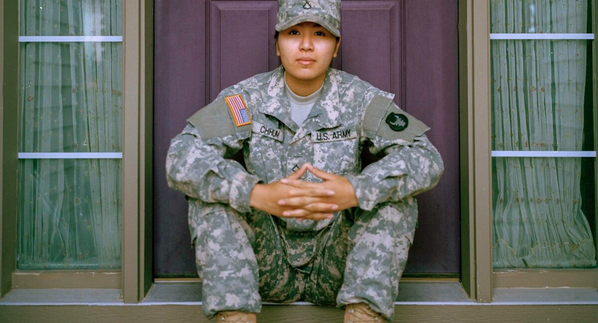 woman sitting in front of closed door